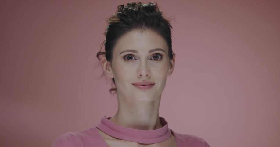 A woman turns her head and smiles as she poses