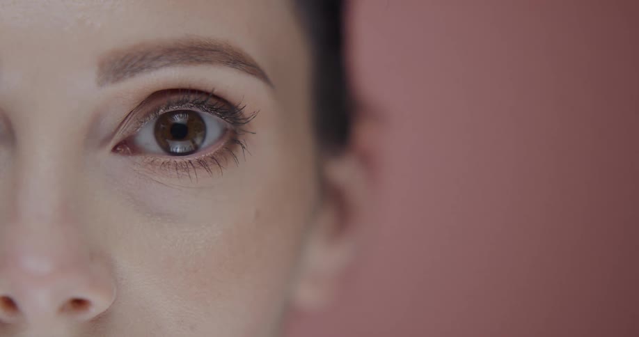 Close up view of a woman wearing makeup is displayed