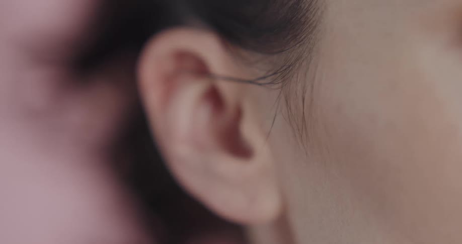 Close up view of the side of a womans face is displayed