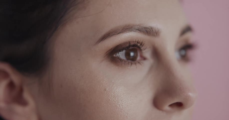 A close up of a womans face with makeup on