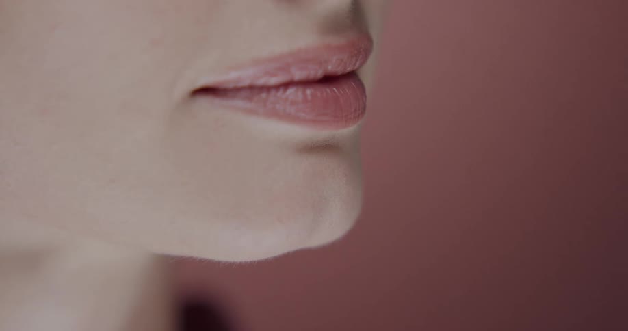 Close up view of a womans face wearing makeup is displayed