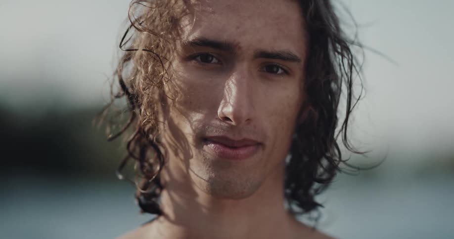 A man is standing outdoors at the beach