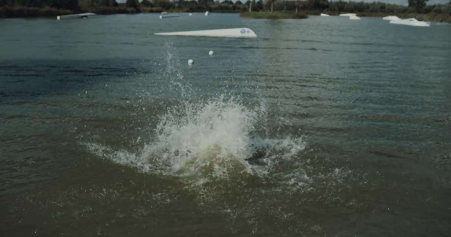 A man runs and jumps in the water