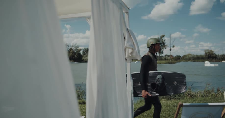 Young man is walking outside to go in the water