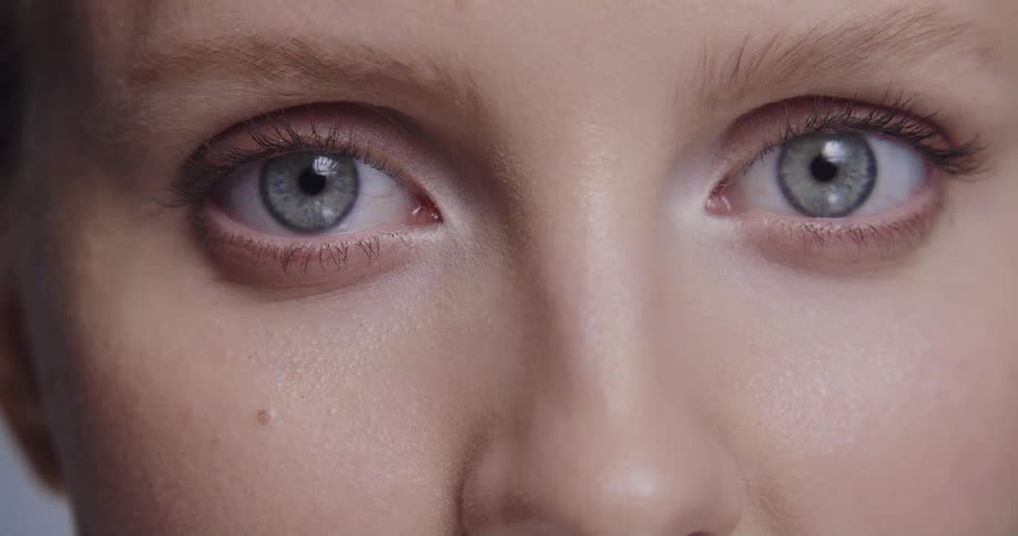 Close up of female models face with blue eyes staring at camera