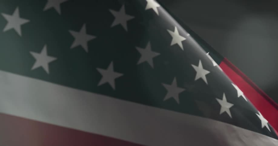 An american flag is wavering in the wind