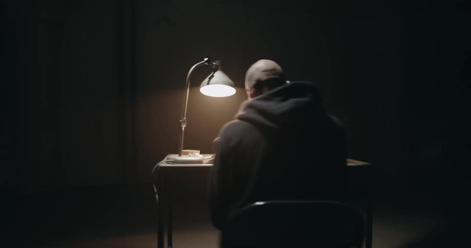 Two men are sitting at a desk throwing papers around and arguing