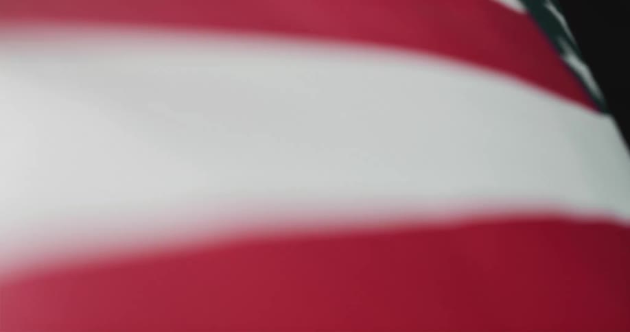An american flag is wavering in the wind