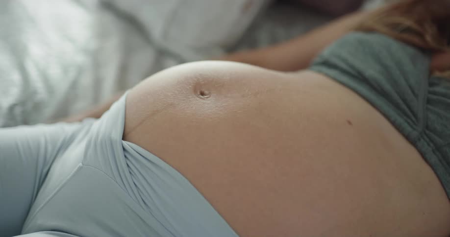 Pregnant woman is laying down