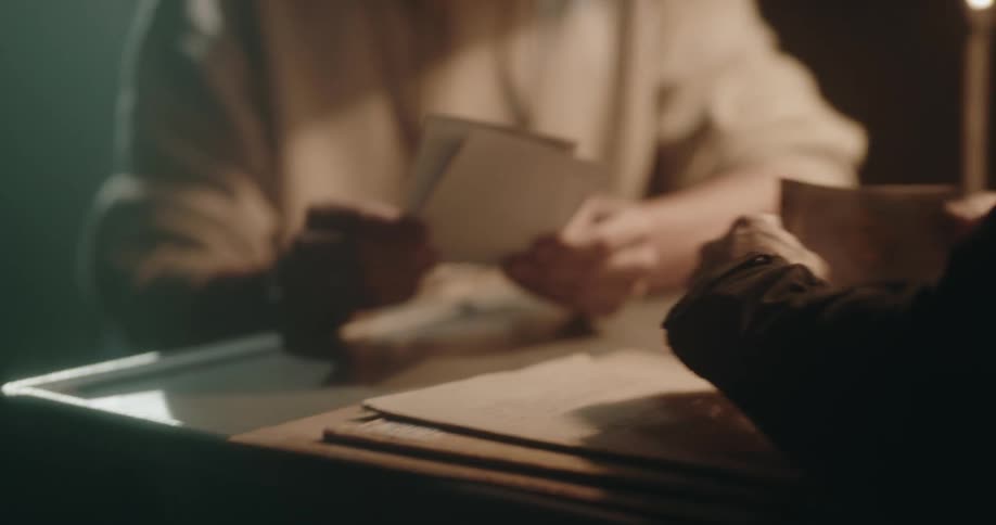 A man is being shown photos in an interrogation