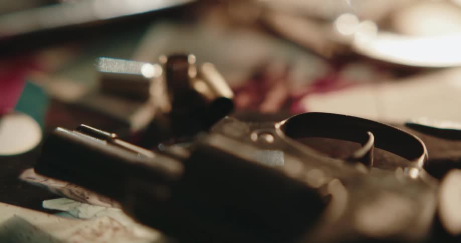 Knife and gun lie on blood stained tiles near spent shell casings