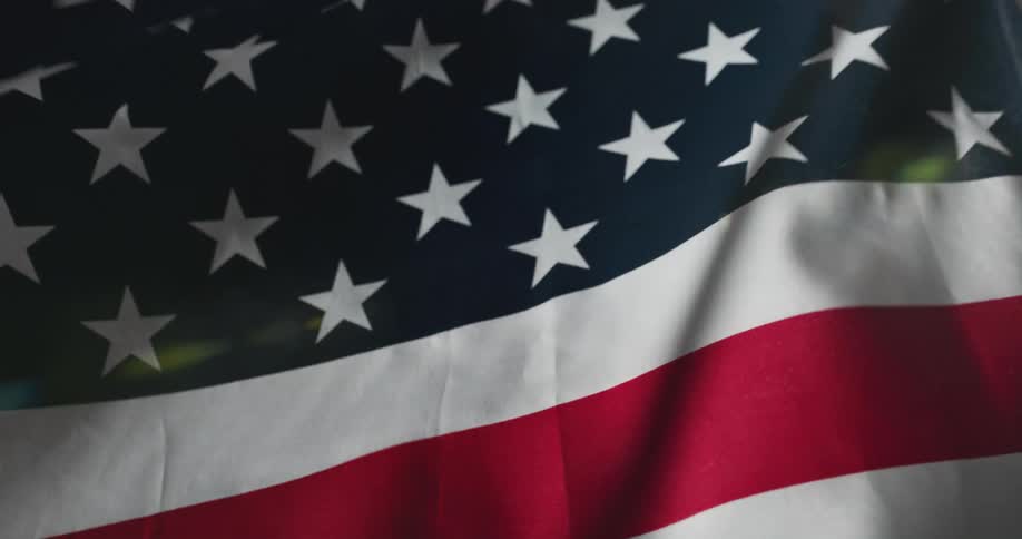 An american flag is wavering in the wind