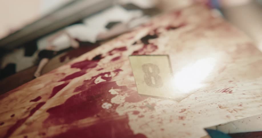 Close up of photographic evidence of a crime scene over a desk