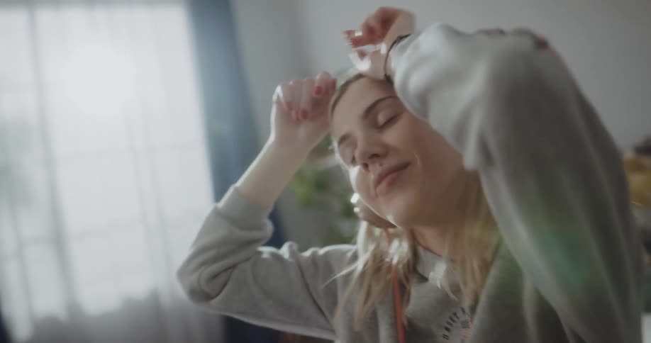 Young woman is listening to music
