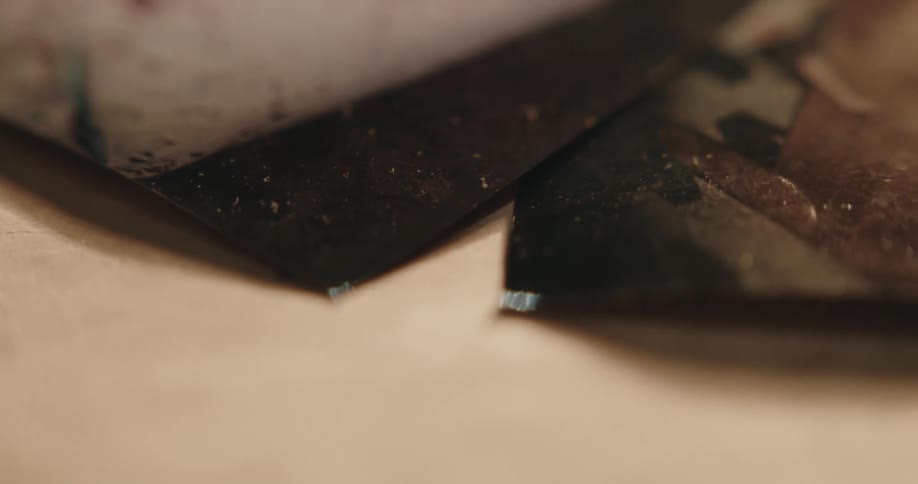 Close up of photographs of a gruesome crime scene over a desk