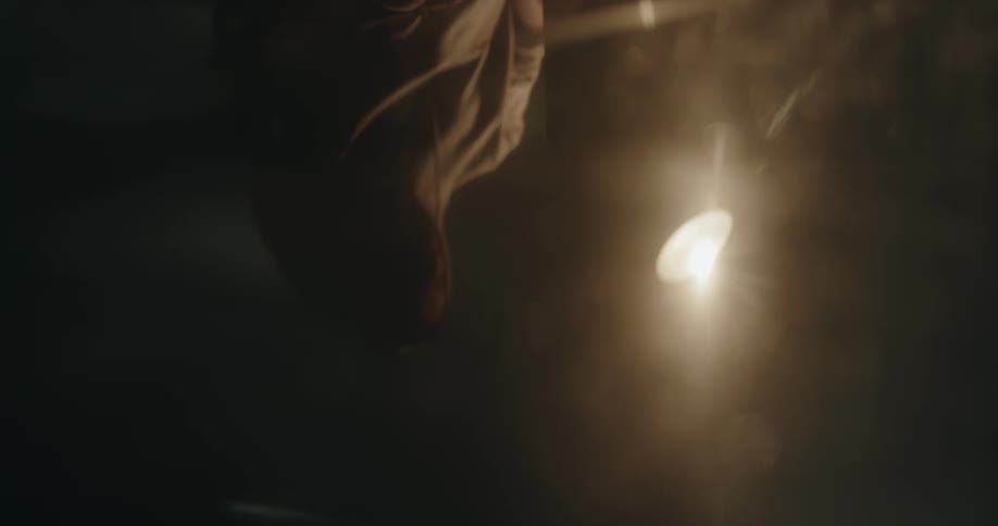 A man is sitting in the dark