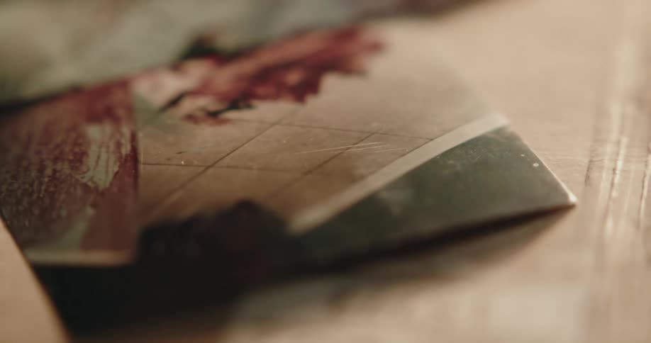 Photographic evidence of a gruesome crime scene over a table