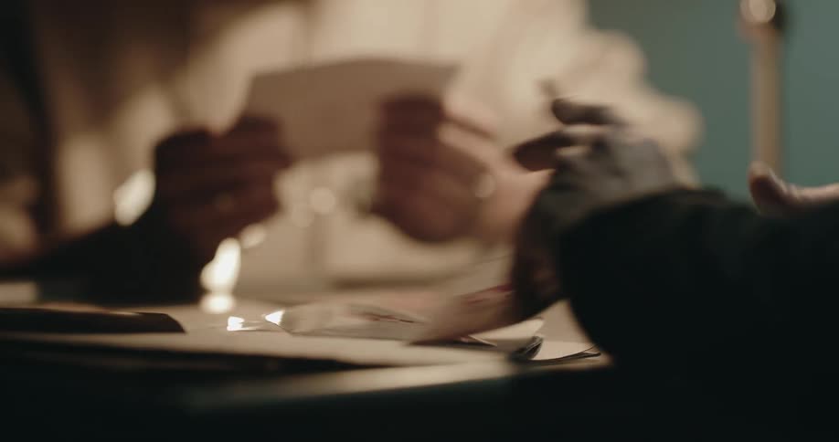 A police officer interrogating a suspect in handcuffs