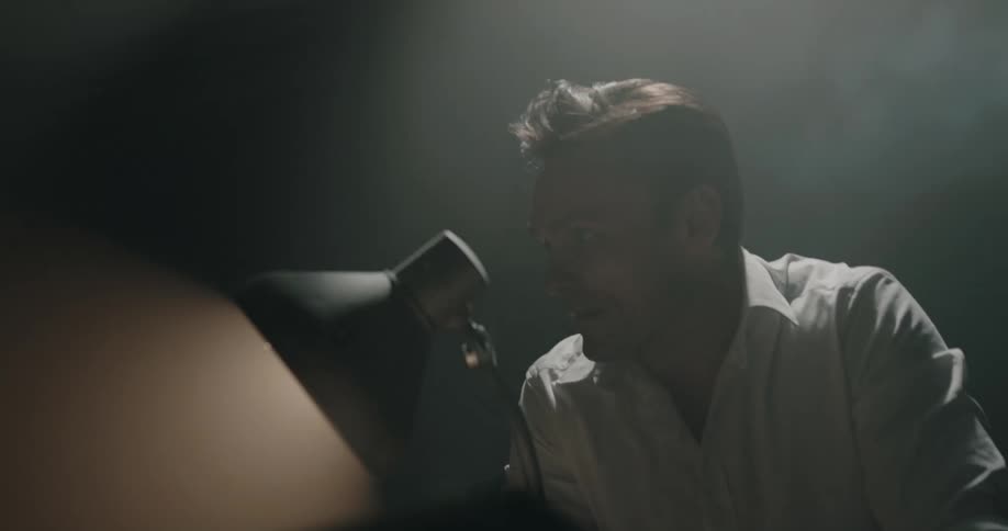 A man yelling at another person sitting at a desk
