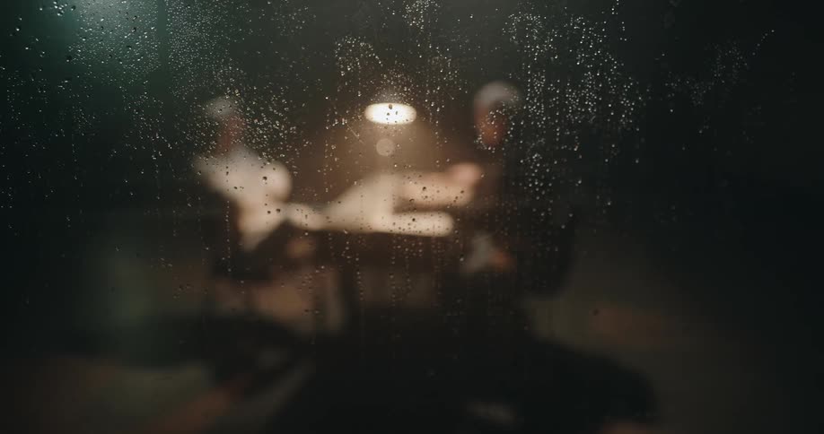 Two people are sitting at a table and talking