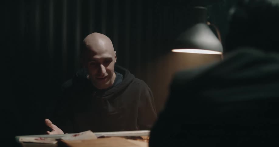 A man speaks animatedly during a police interrogation