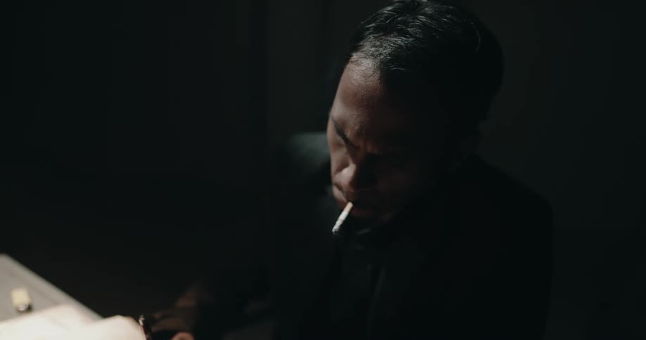 A man is smoking at the table