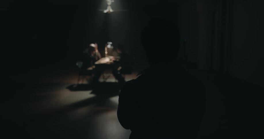 A man is being interrogated in the room