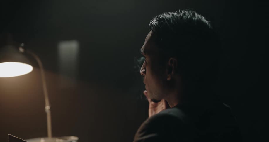 A police offer smokes while interrogating someone