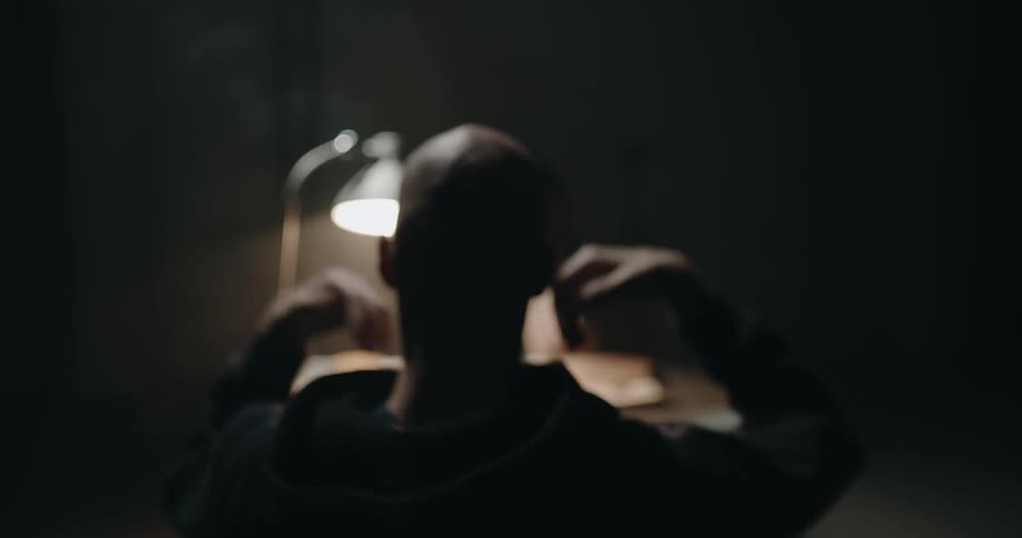 Silhouette of a suspect sitting on a chair in an interrogation room