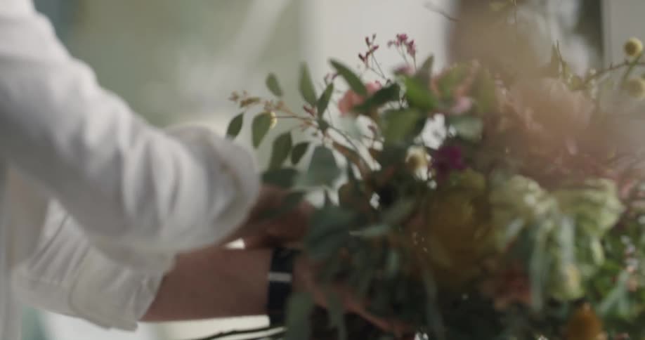 A person working on building a bouquet