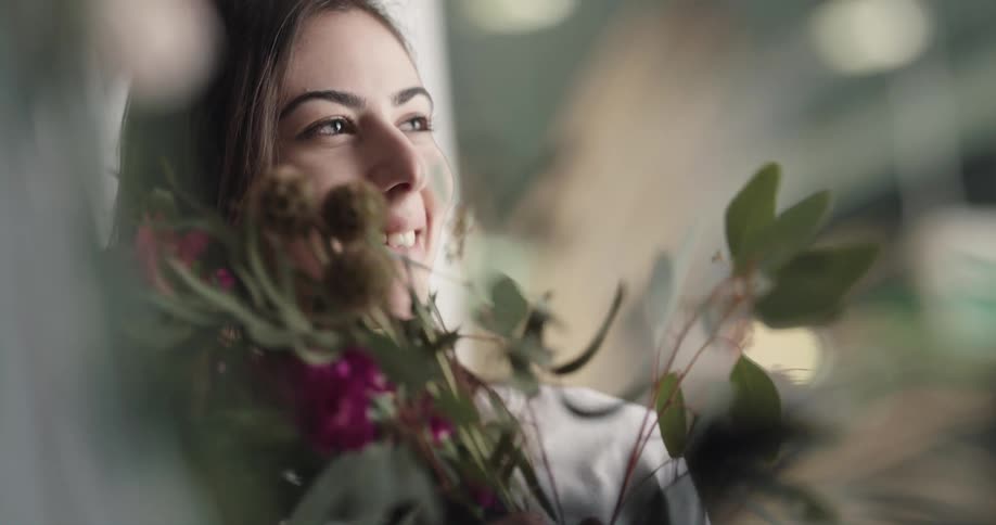 Young woman receives a bouquet of flowers