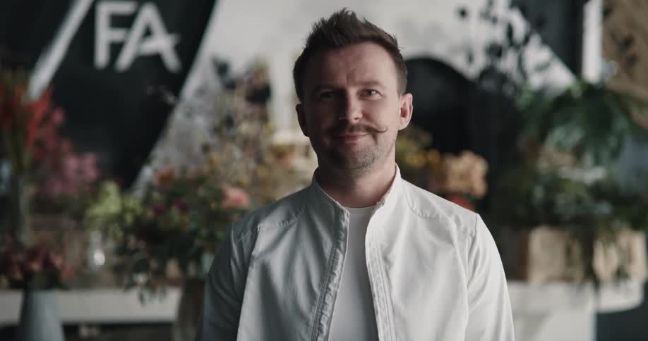 An employee is smiling in the flower shop