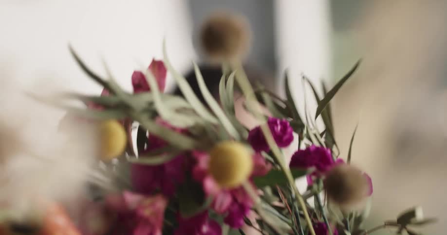 A woman bunches up some flowers