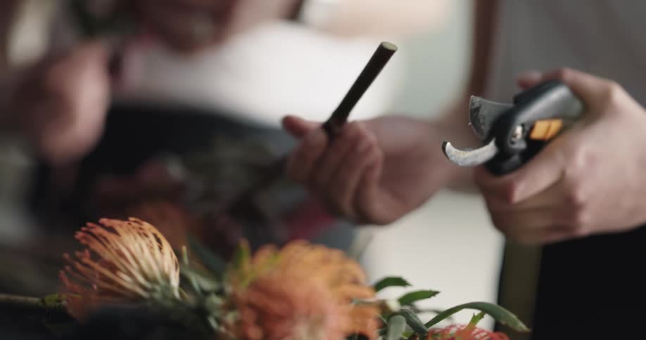 Flower stem being but with cutters at a flower shop