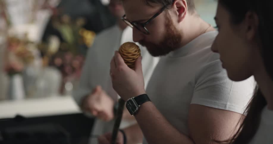 A man smells a flower in the florist