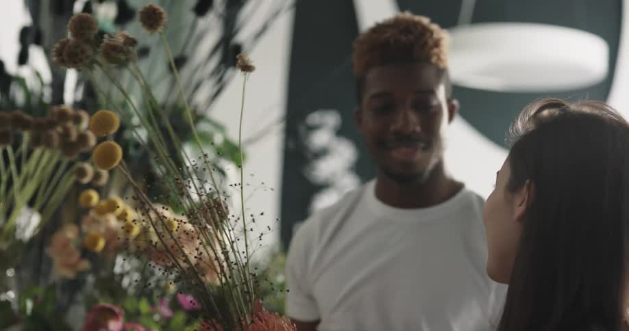 A man and woman shopping for flowers