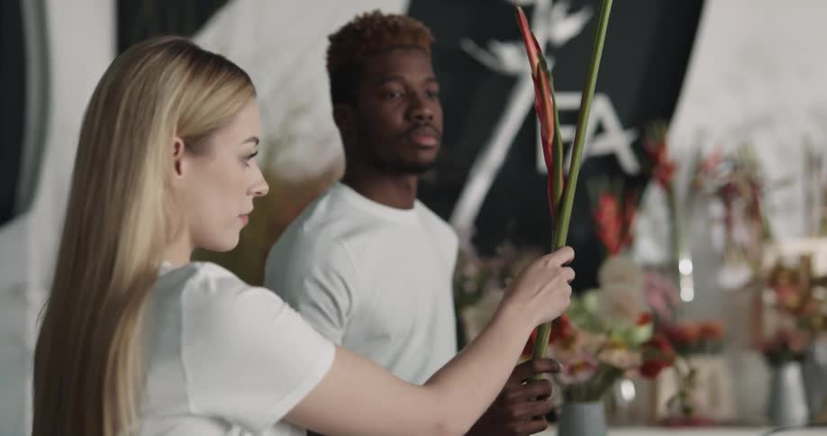 Employees arranging flowers for a client in a flower shop