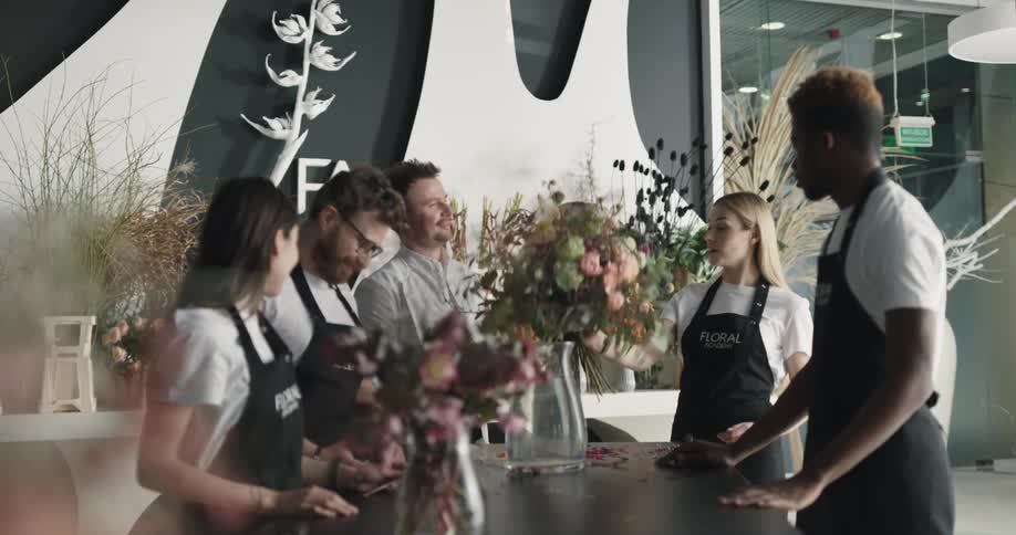 Boss teaching employees how to assemble a flower bouquet
