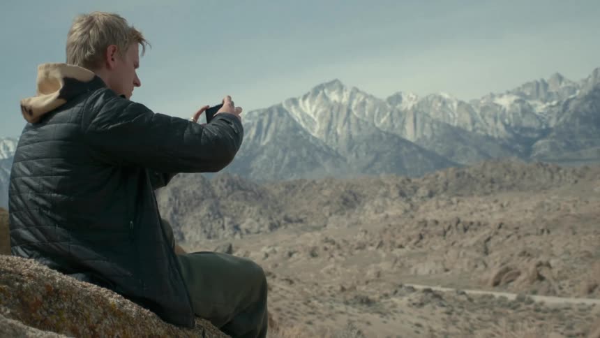 A man takes photographs on the mountain