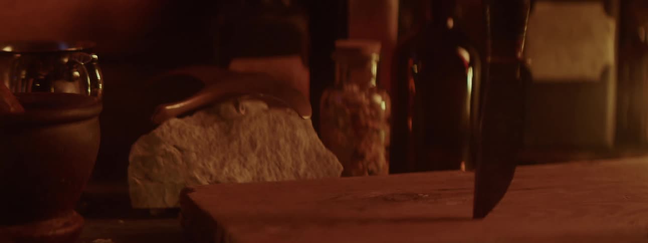 A view of a knife being stabbed into a table