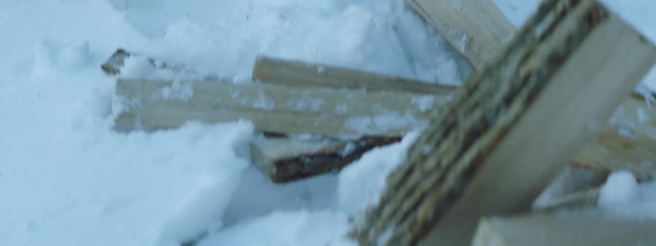 Man is hitting the wood with an ax