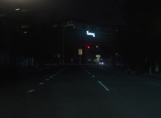 Vehicle drives on highway in the city at night