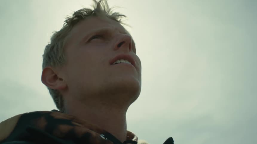 Blonde man with pointed nose looks around under the shining sun