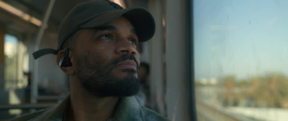 A man is sitting on the bus in the daytime