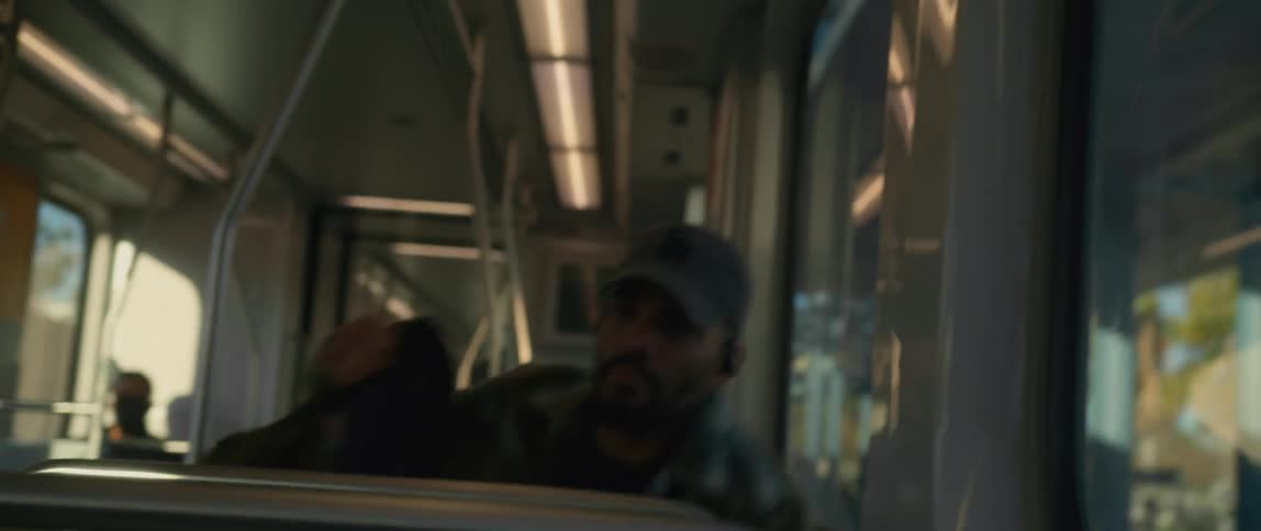 Man carrying a backpack boards a metro train in the morning