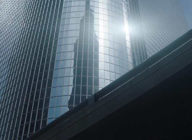 A view of a tall building in a city is displayed