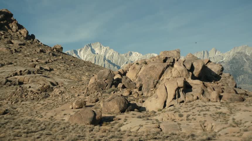 The view is of the desert and you can the mountains