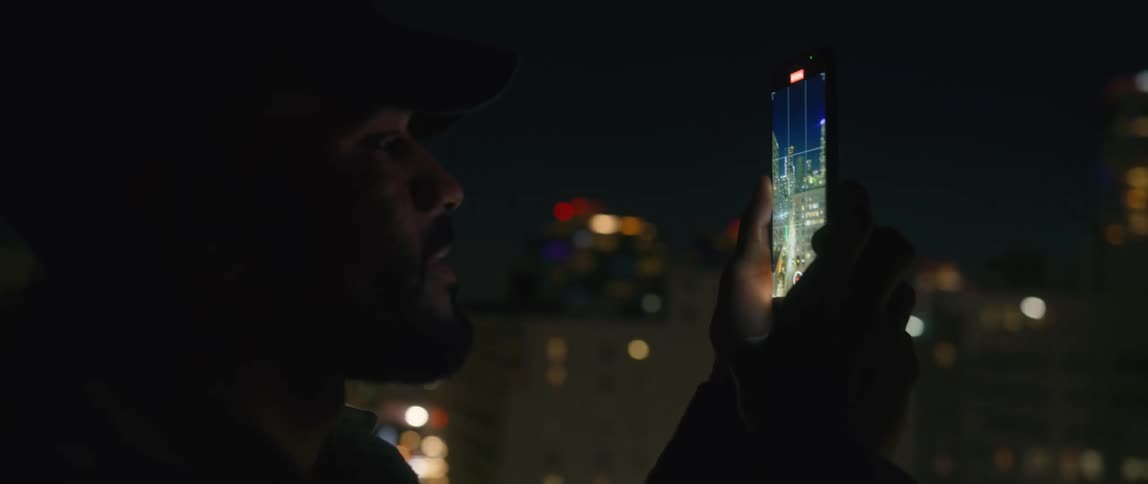 A man is taking a photograph with his phone