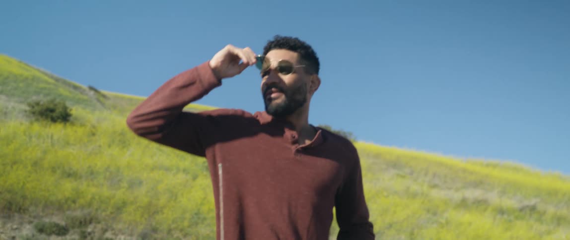 A young man outside in front of the hills