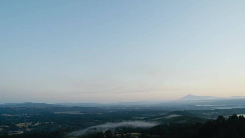 Aerial view of a wide open landscape is displayed at dusk